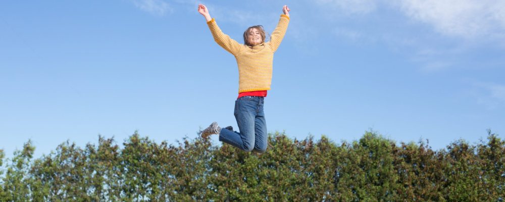 happy-woman-jumps-on-trampoline